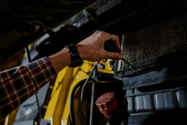 person fixing the engine air filter of a truck